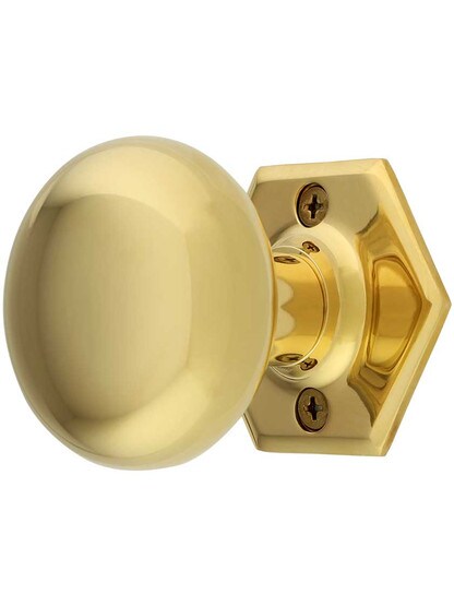 Hexagonal Rosette Door Set with Wrought Brass Knobs in Lacquered Brass.
